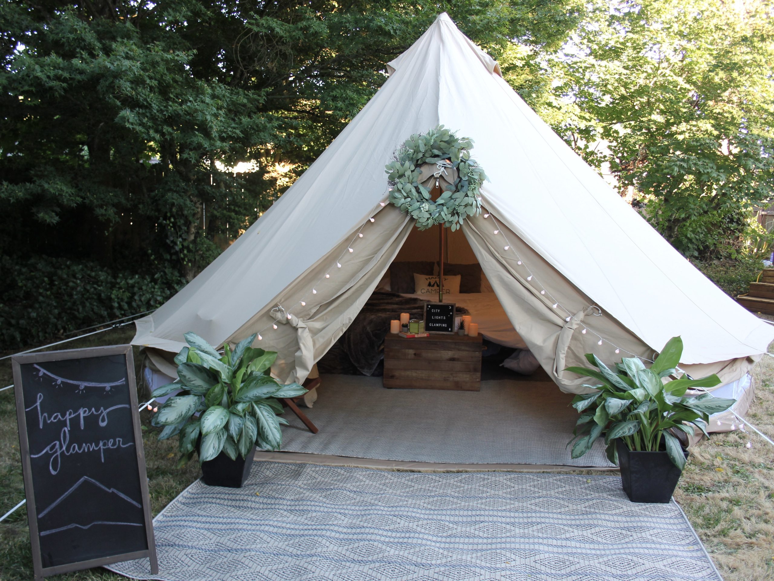 glamping tent with a chalkboard sign outside.